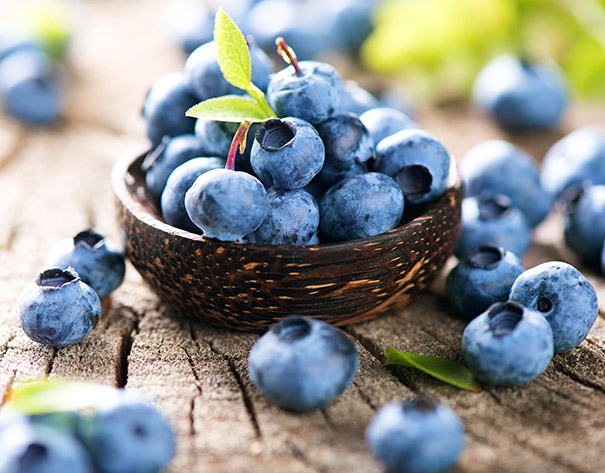 a basket of 'Duke' Blueberries on a wooden surface