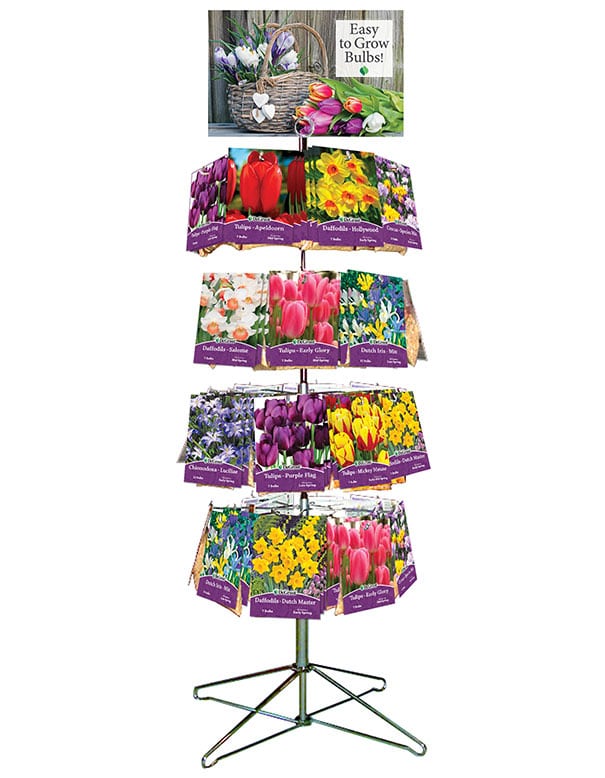 Metal spinner rack with retail packages of fall bulbs hanging on pegs. POP sign attached to the top of the display that says "Easy to Grow Bulbs!" with a basket of flowers.